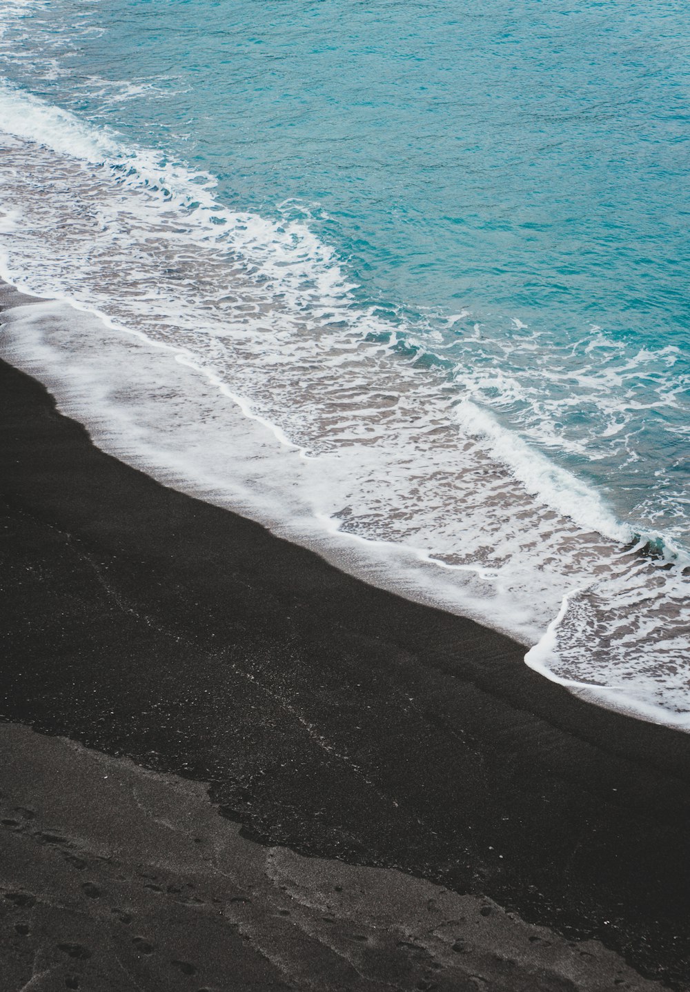 a beach with waves crashing on it