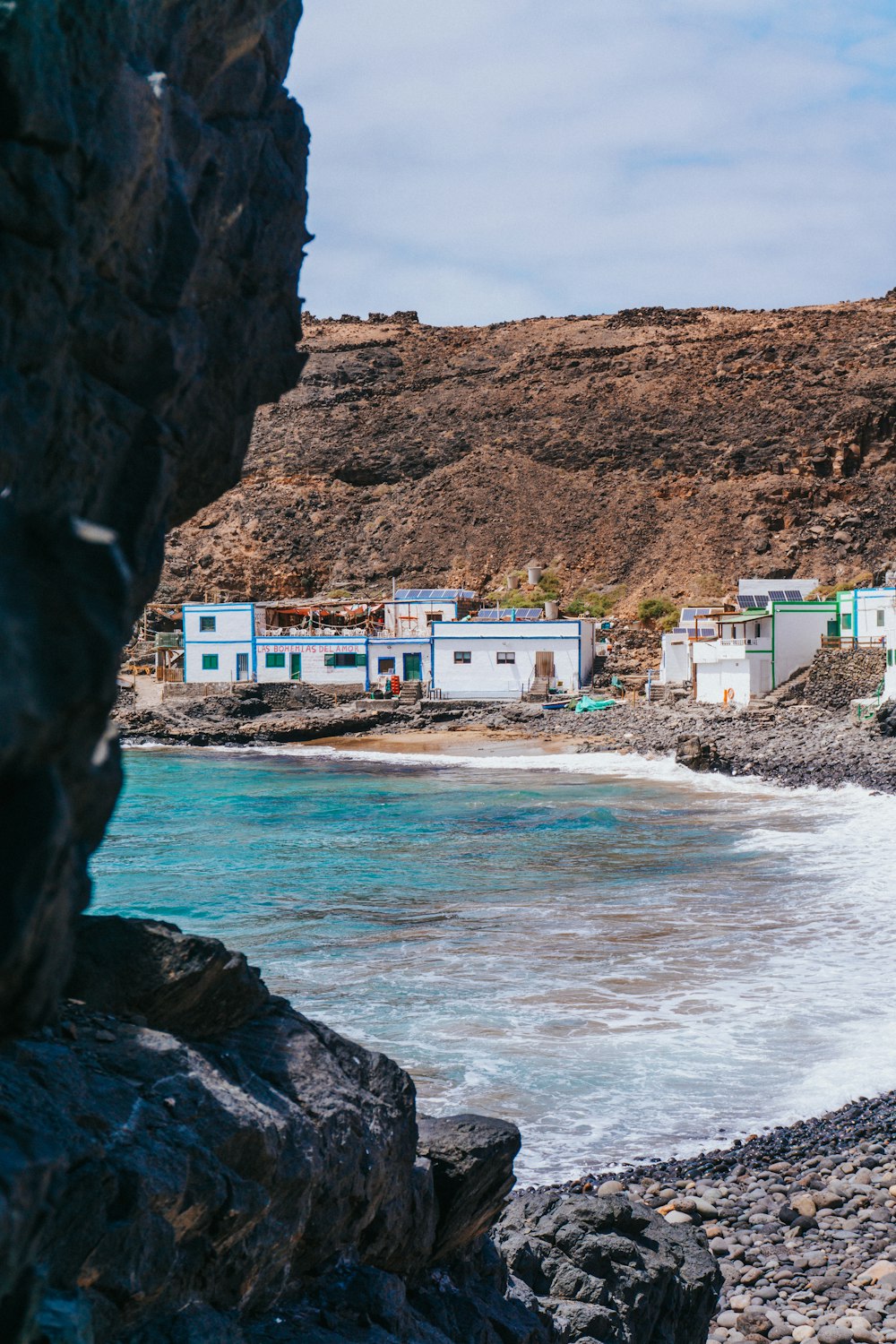 a group of buildings by a body of water