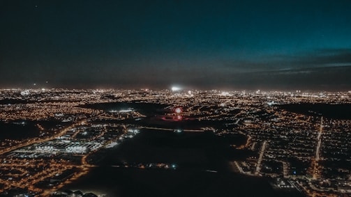 A detailed digital painting of a futuristic cityscape at night with glowing blue lights.