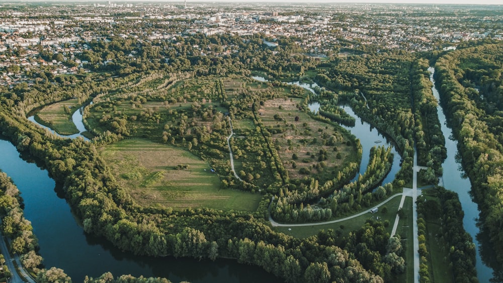 a river with a winding road and trees on either side