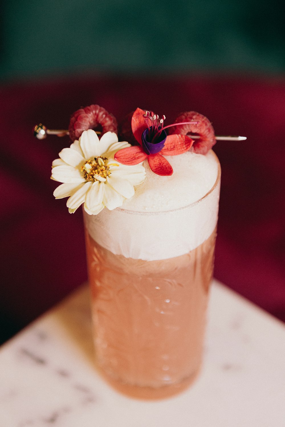 a cup with a flower on a table