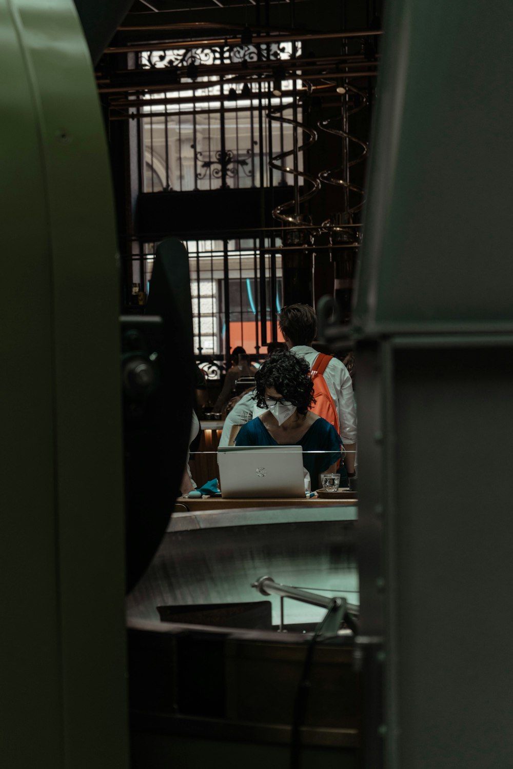 a couple of people sitting at a desk with a laptop