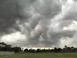 A group of players building a fortified base under a stormy sky