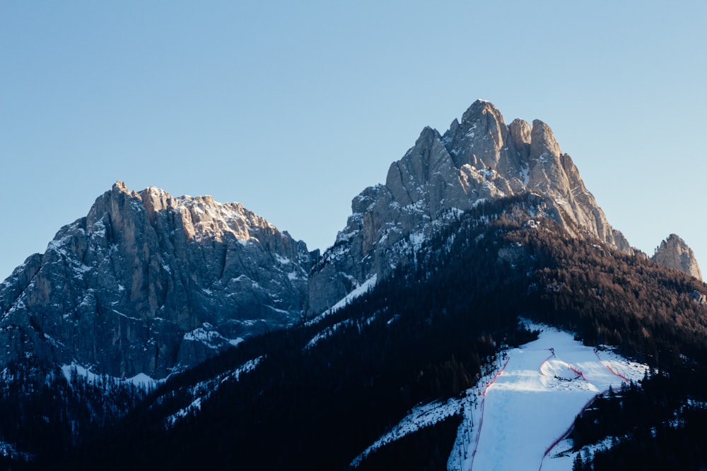 a snowy mountain with a river running through it