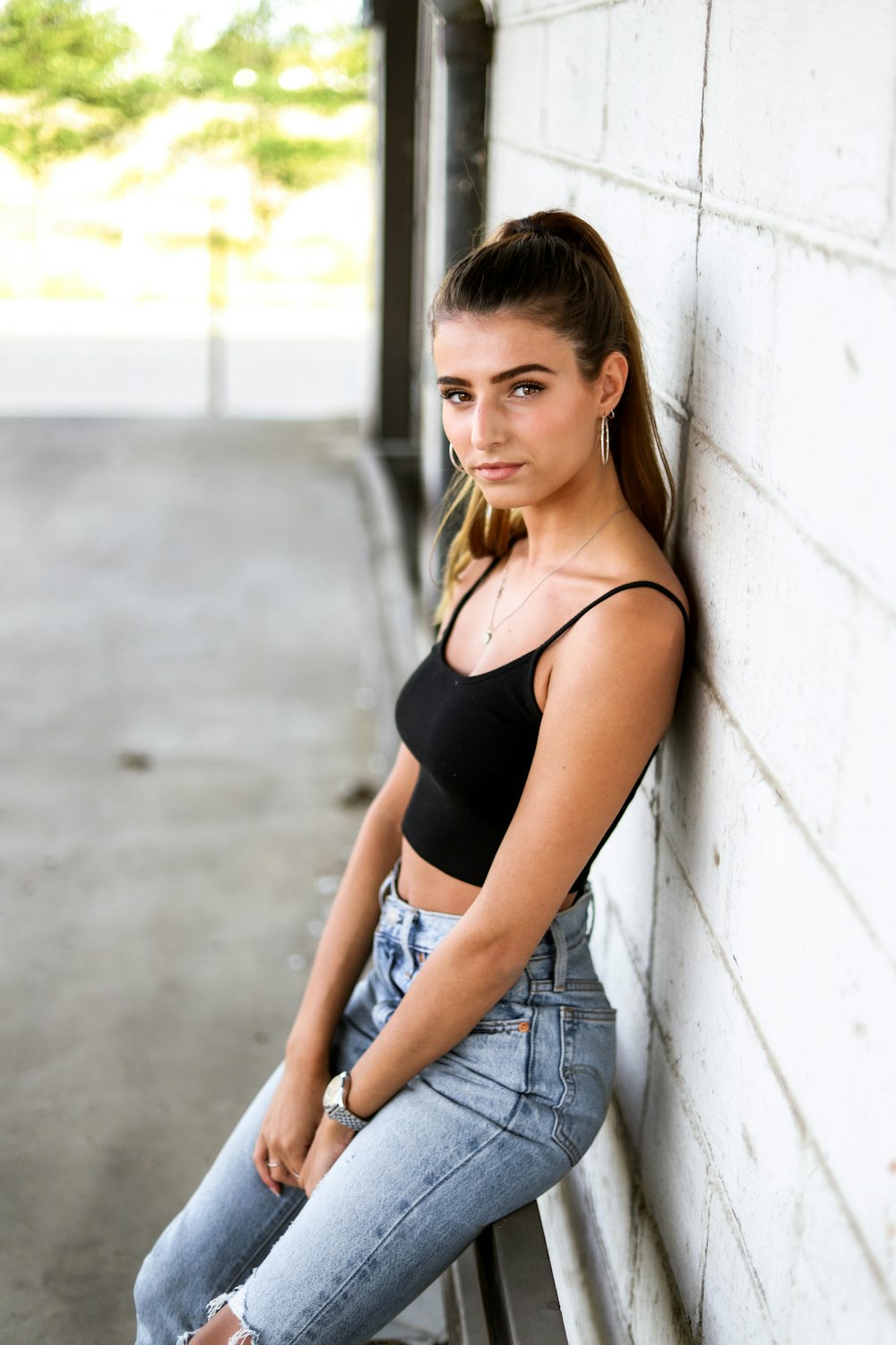 a woman leaning against a wall