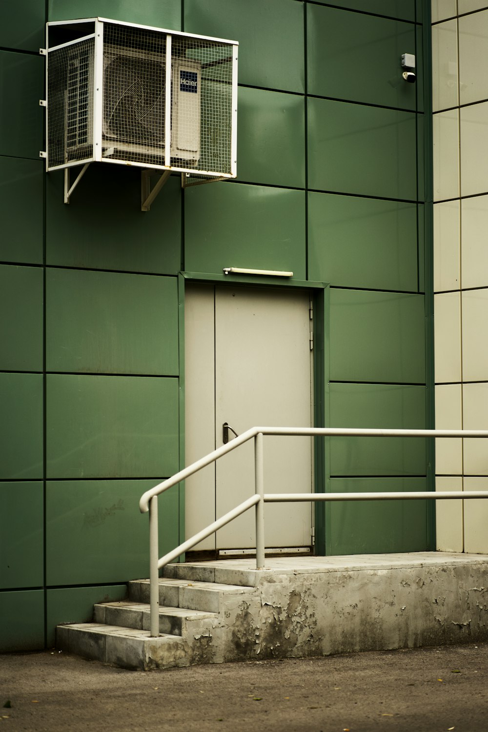 a green wall with a white door