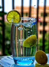 A refreshing glass of water with lemon slices on a wooden table.
