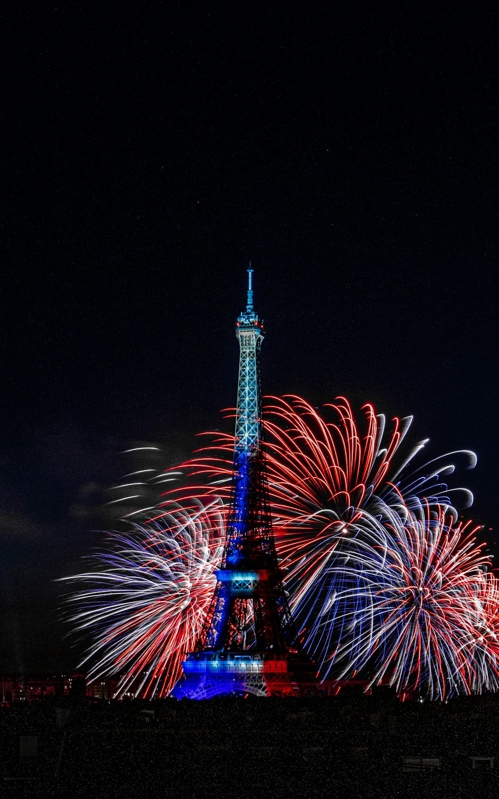 a tall tower with fireworks in the sky