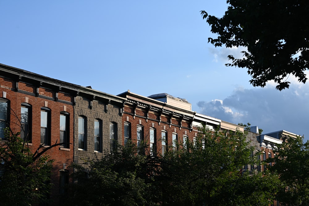 a brick building with trees in front of it