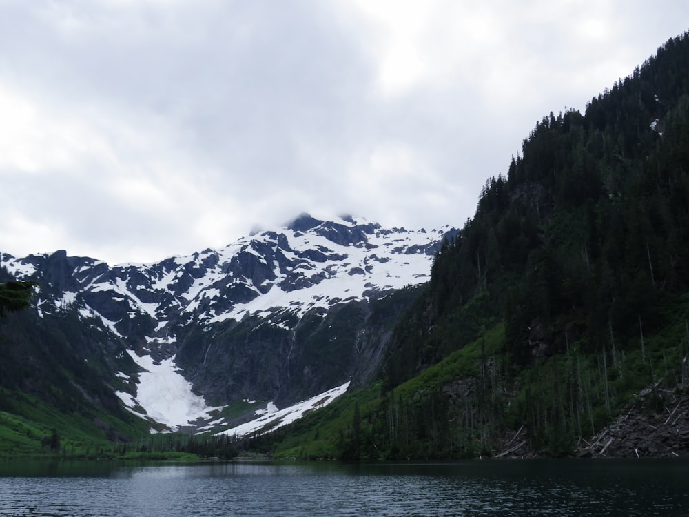 a body of water with mountains in the back