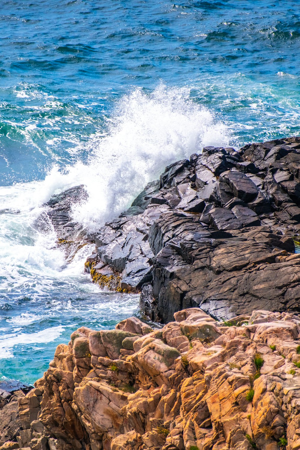 a rocky shoreline with waves crashing