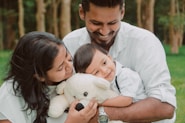 a man and woman holding a baby