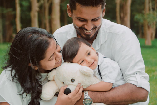 a man and woman holding a baby