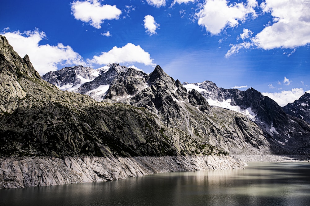 a body of water with mountains in the back