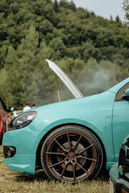 a blue car with a white umbrella on the roof