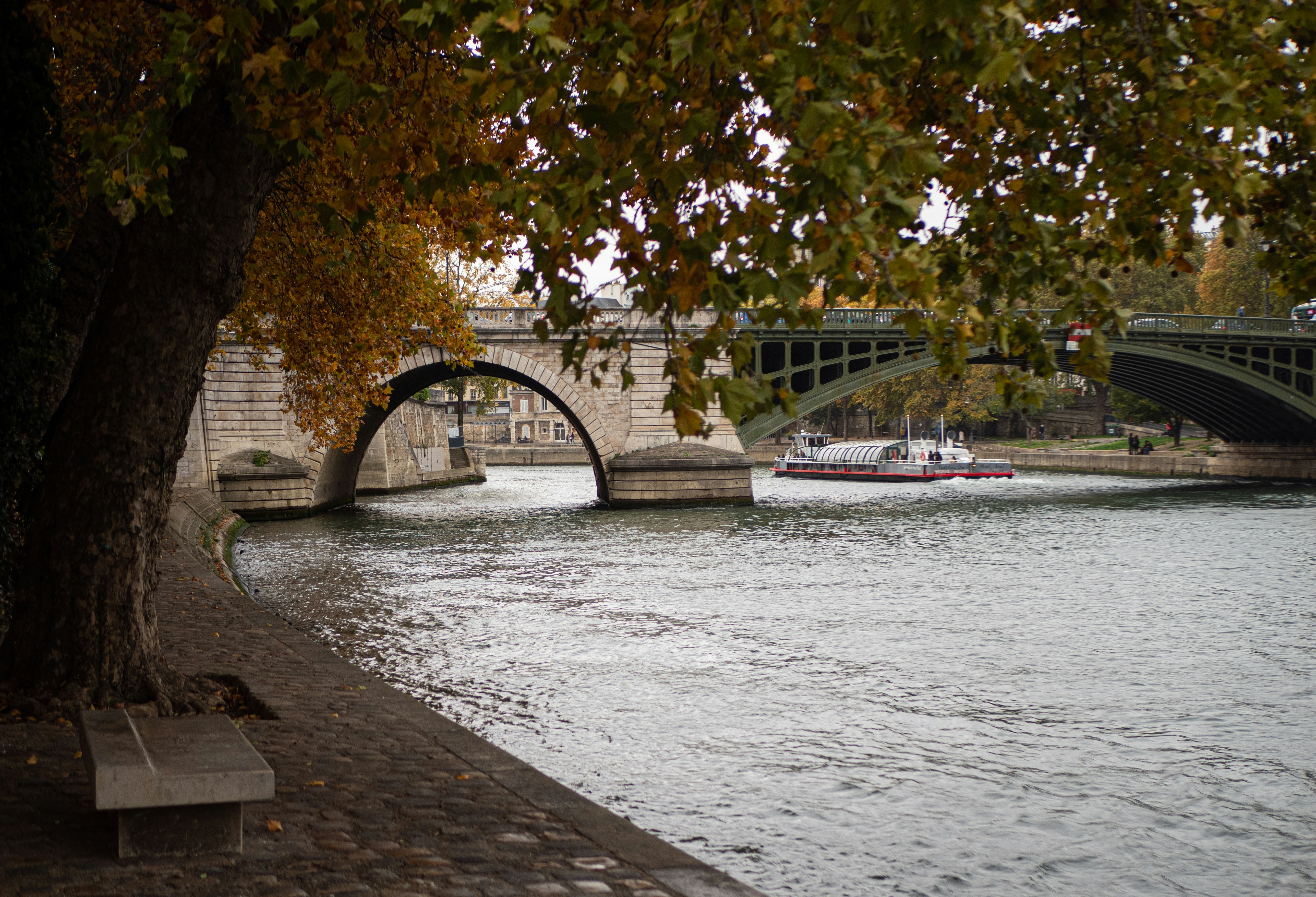 a boat sailing under a bridge, Paris, France.