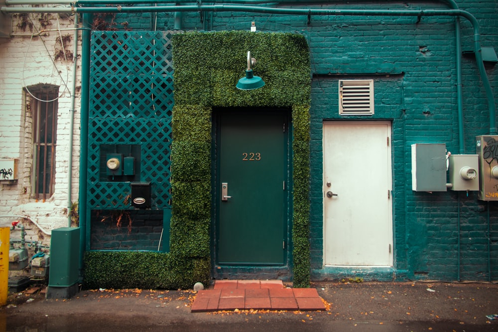 a green door next to a building