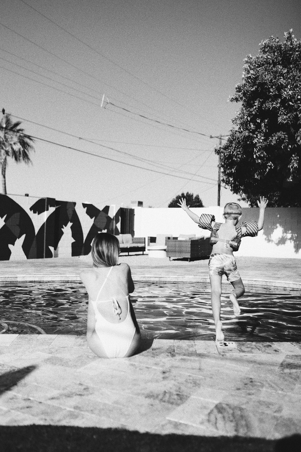 a couple of children playing in a pool