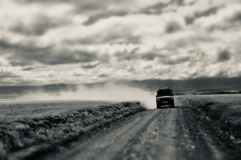 a couple of cars driving on a dirt road with smoke coming out of the tires