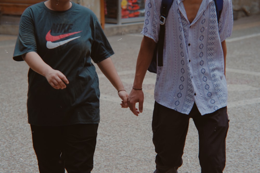 a pair of people holding hands