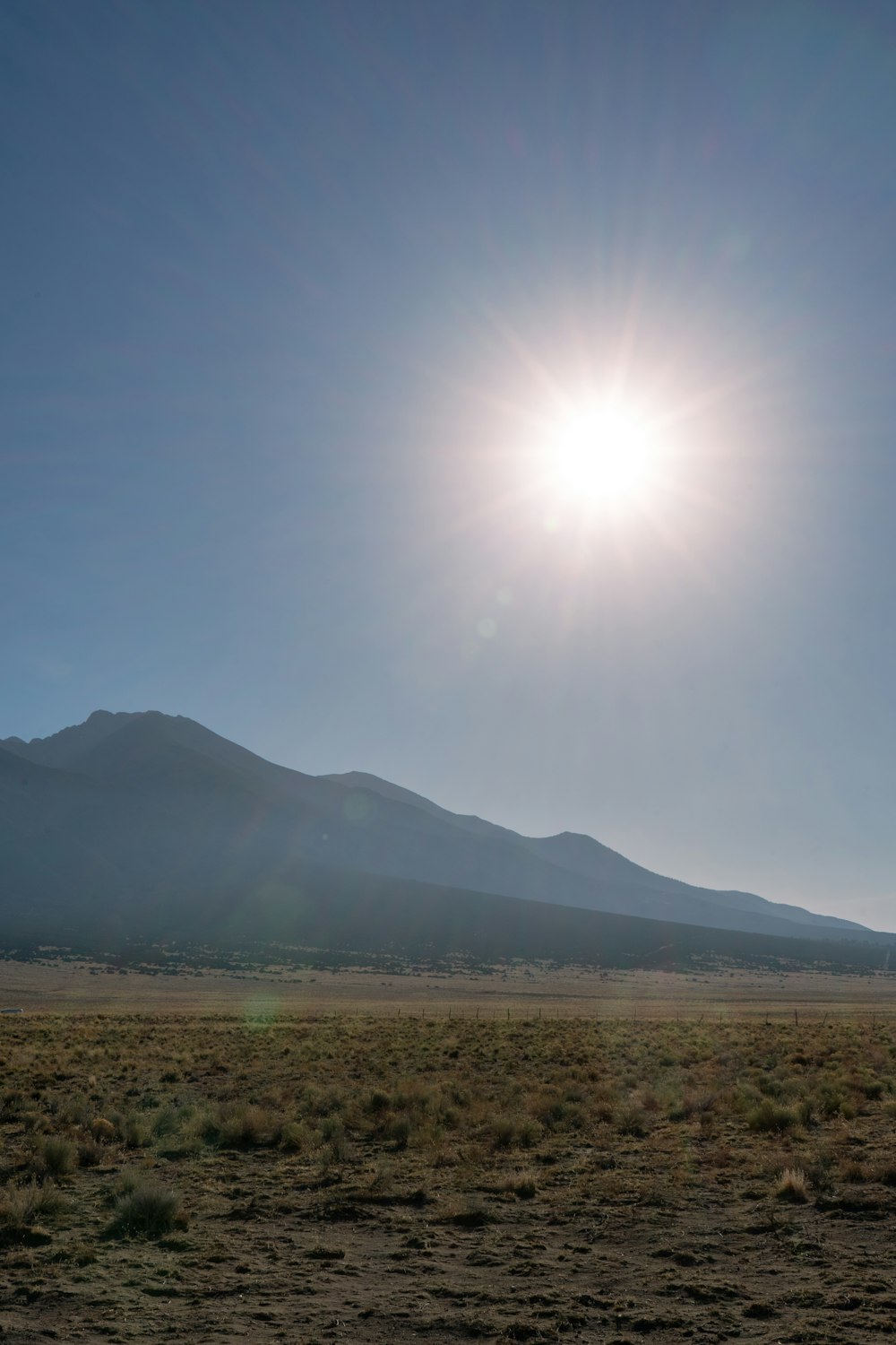 a landscape with a mountain in the background