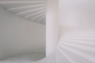 a white staircase with white walls