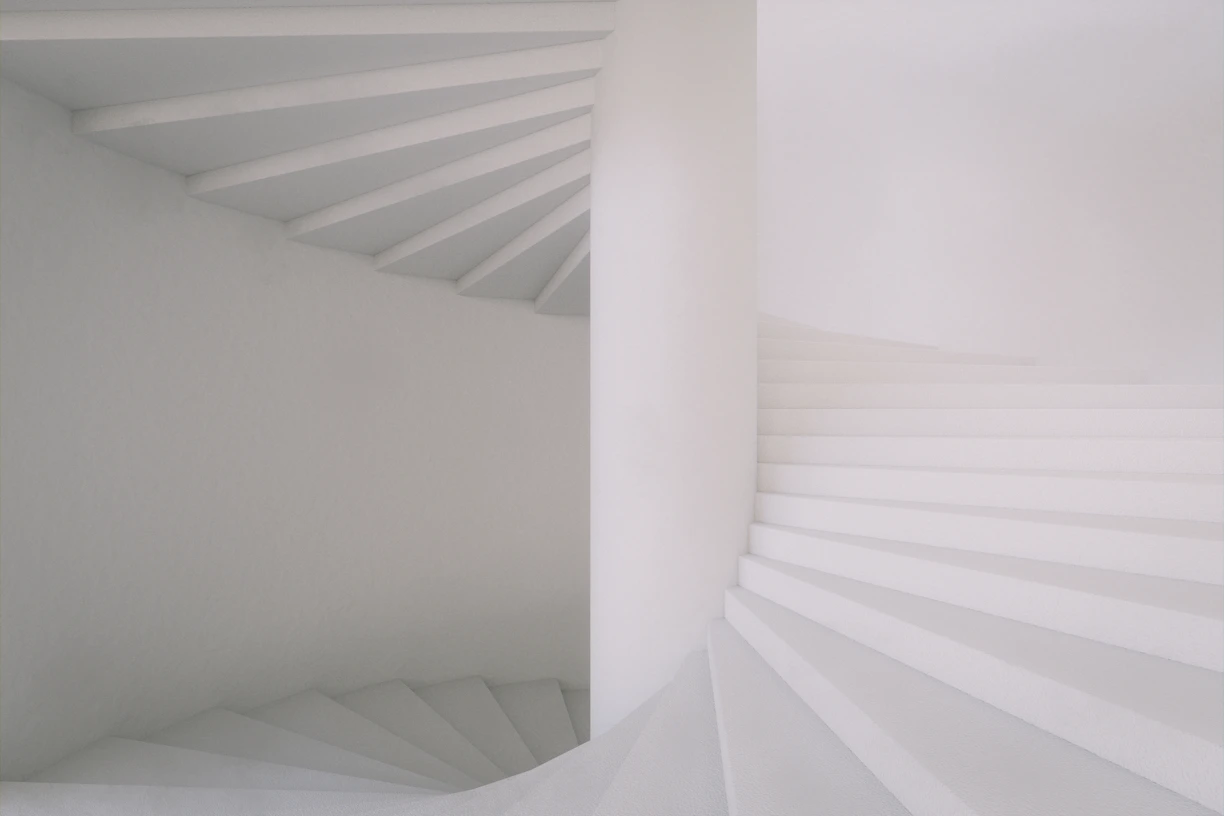 a white staircase with white walls