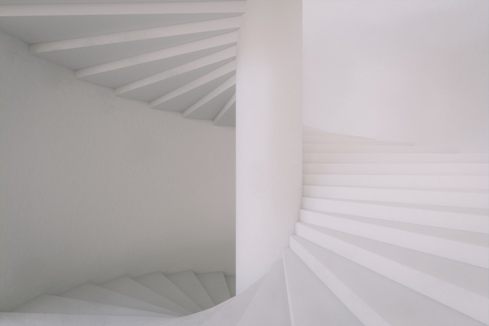 a white staircase with white walls