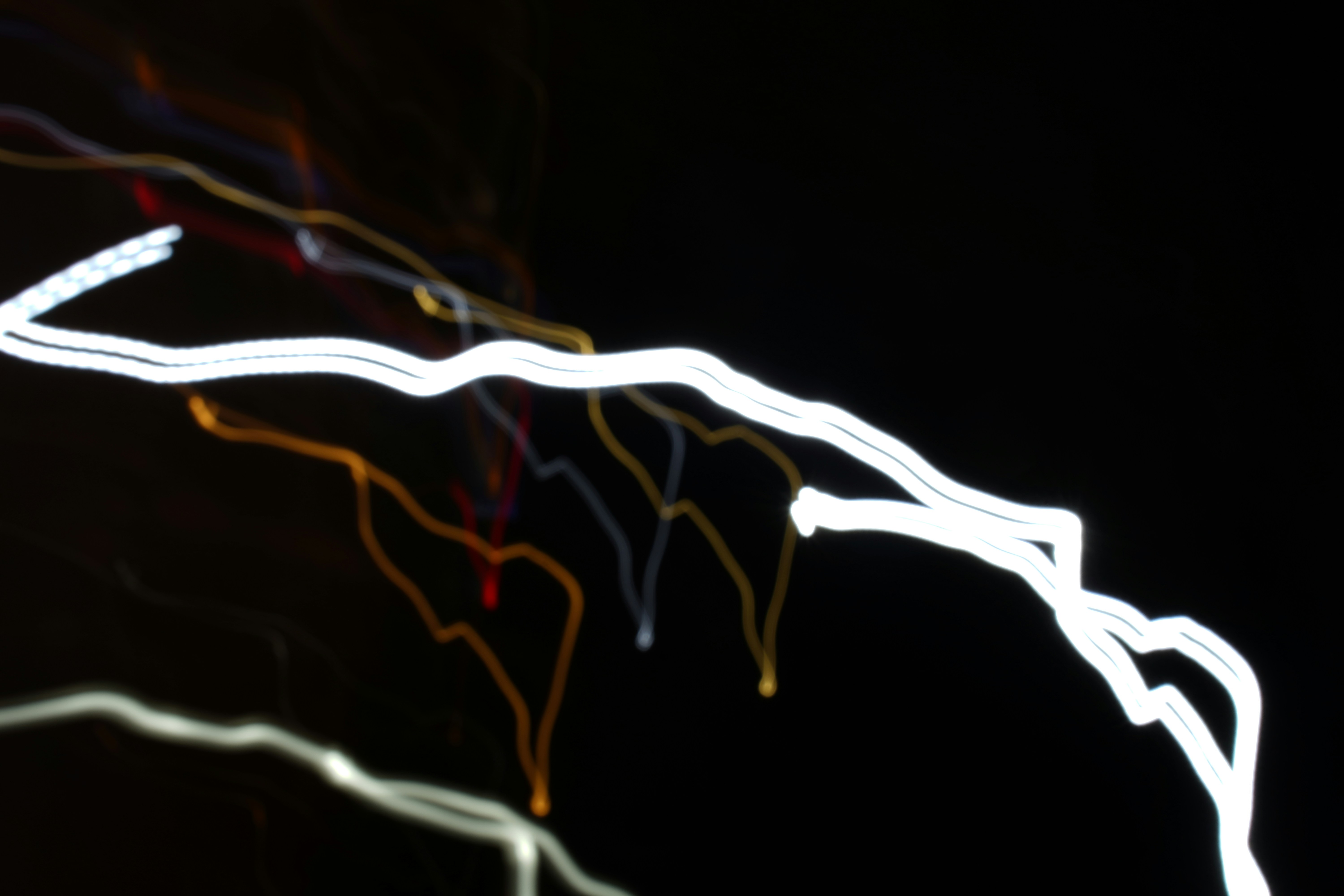 Abstract, flowing trails of light forming complex new shapes on a dark background, representing the foundational shifts AI is creating in industries.