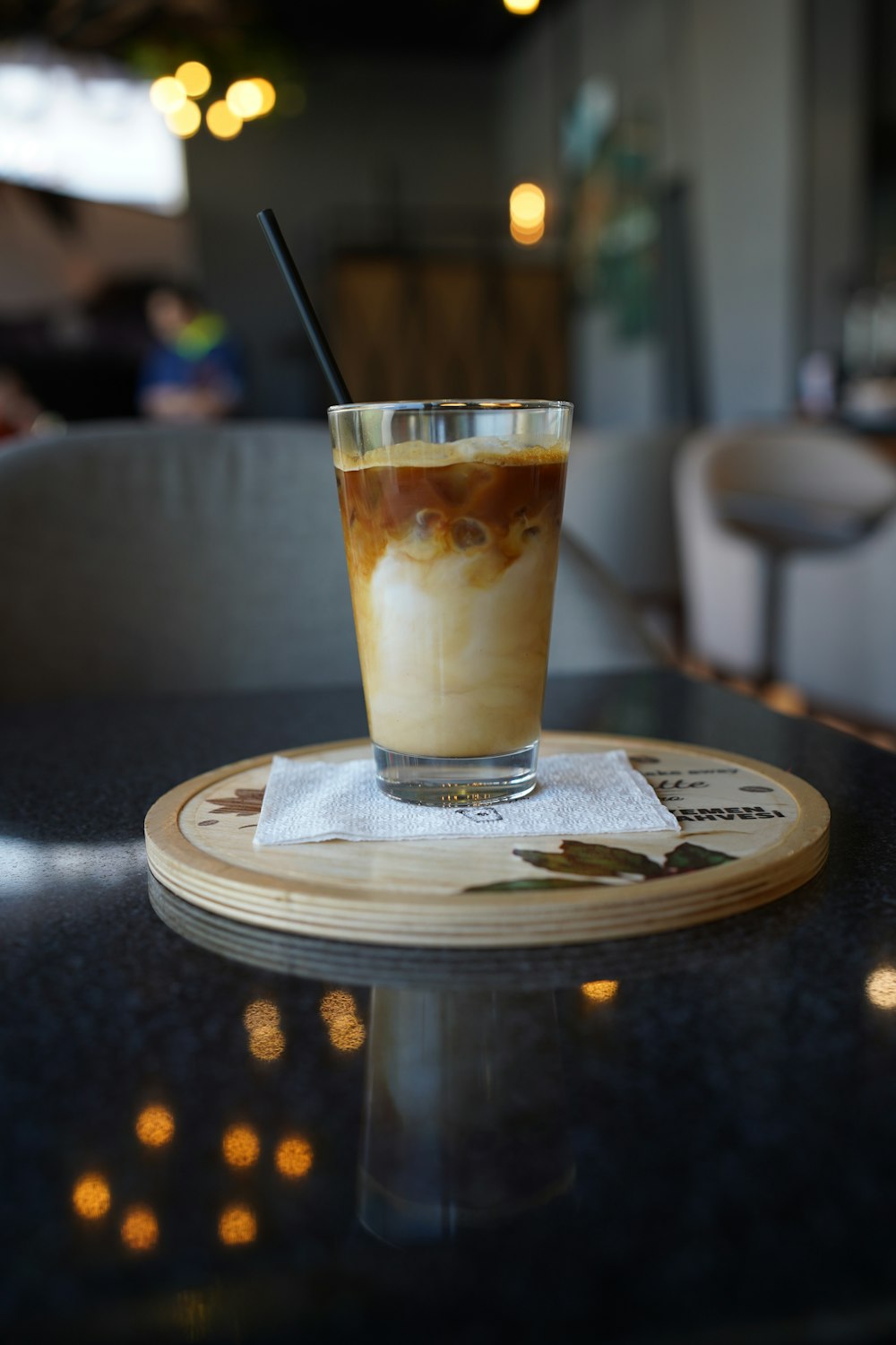 a glass of beer on a coaster