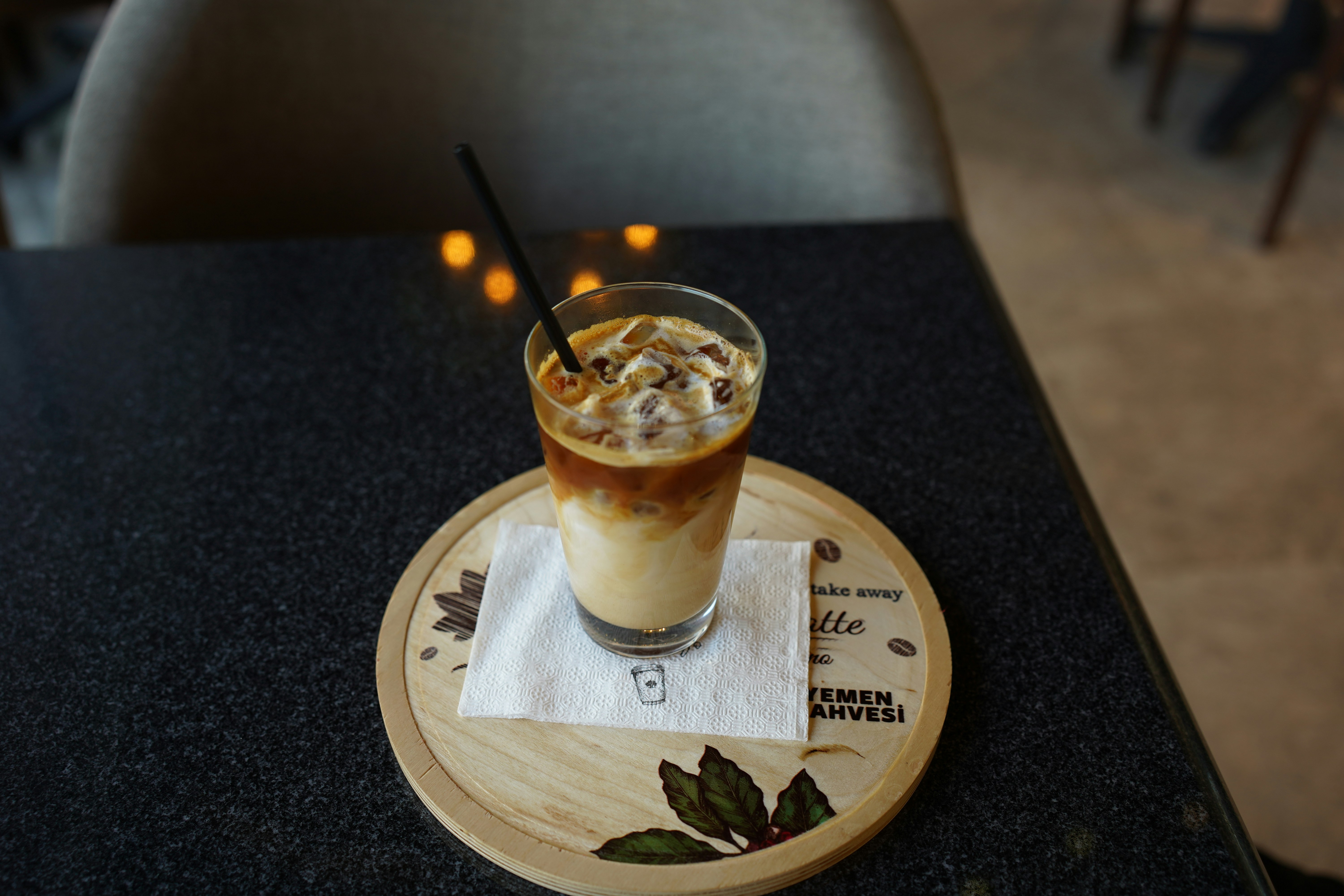 a glass of liquid with a straw