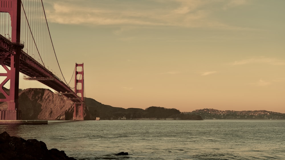 a large red bridge over water