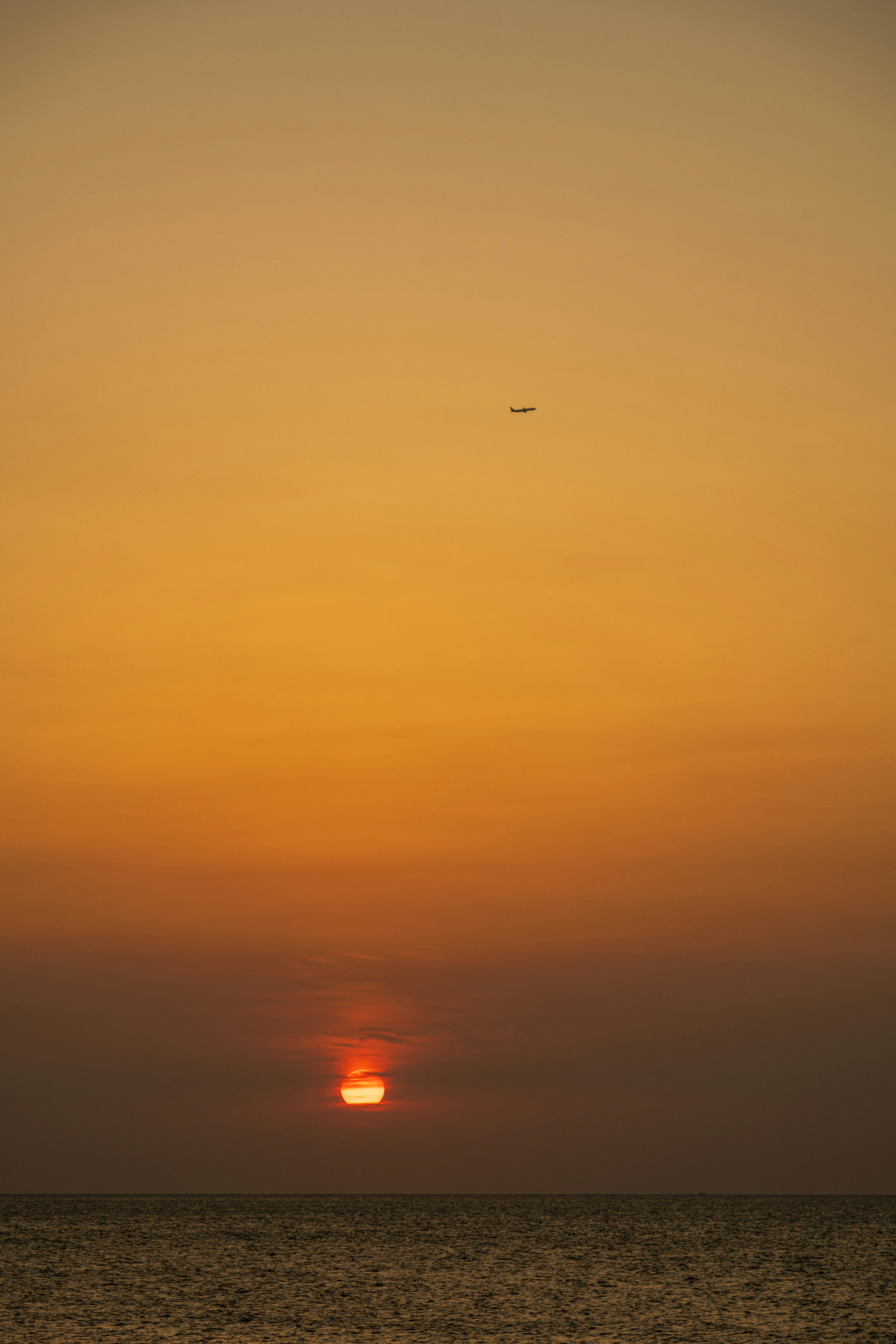 a plane flying over the ocean