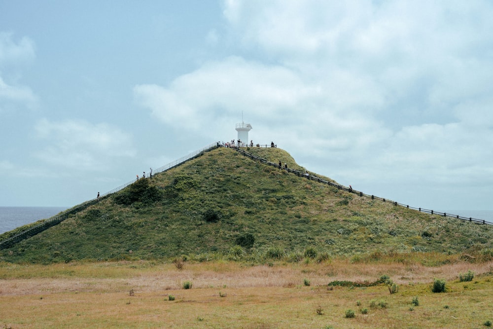 a white tower on a hill