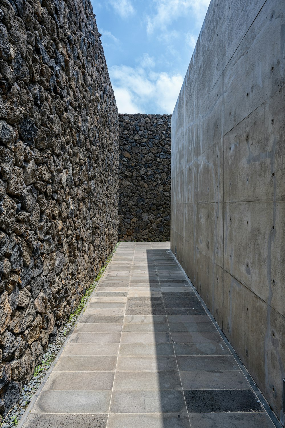 a stone walkway between stone walls