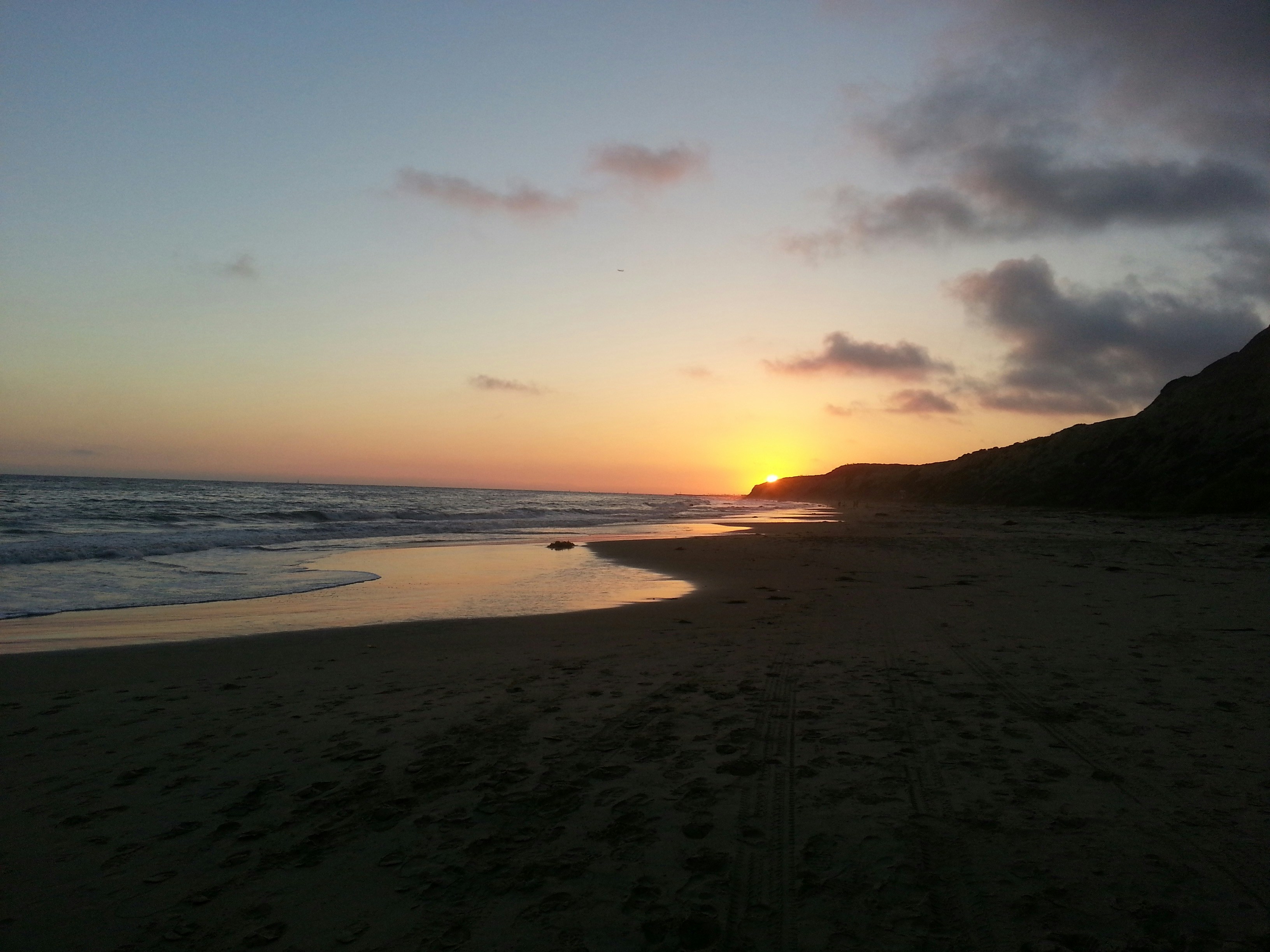 a beach with a sunset