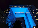 Evening shot of the council’s headquarters illuminated with blue and cyan lighting, symbolizing innovation.