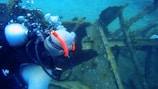 A certified diver inspecting a commercial vessel underwater.