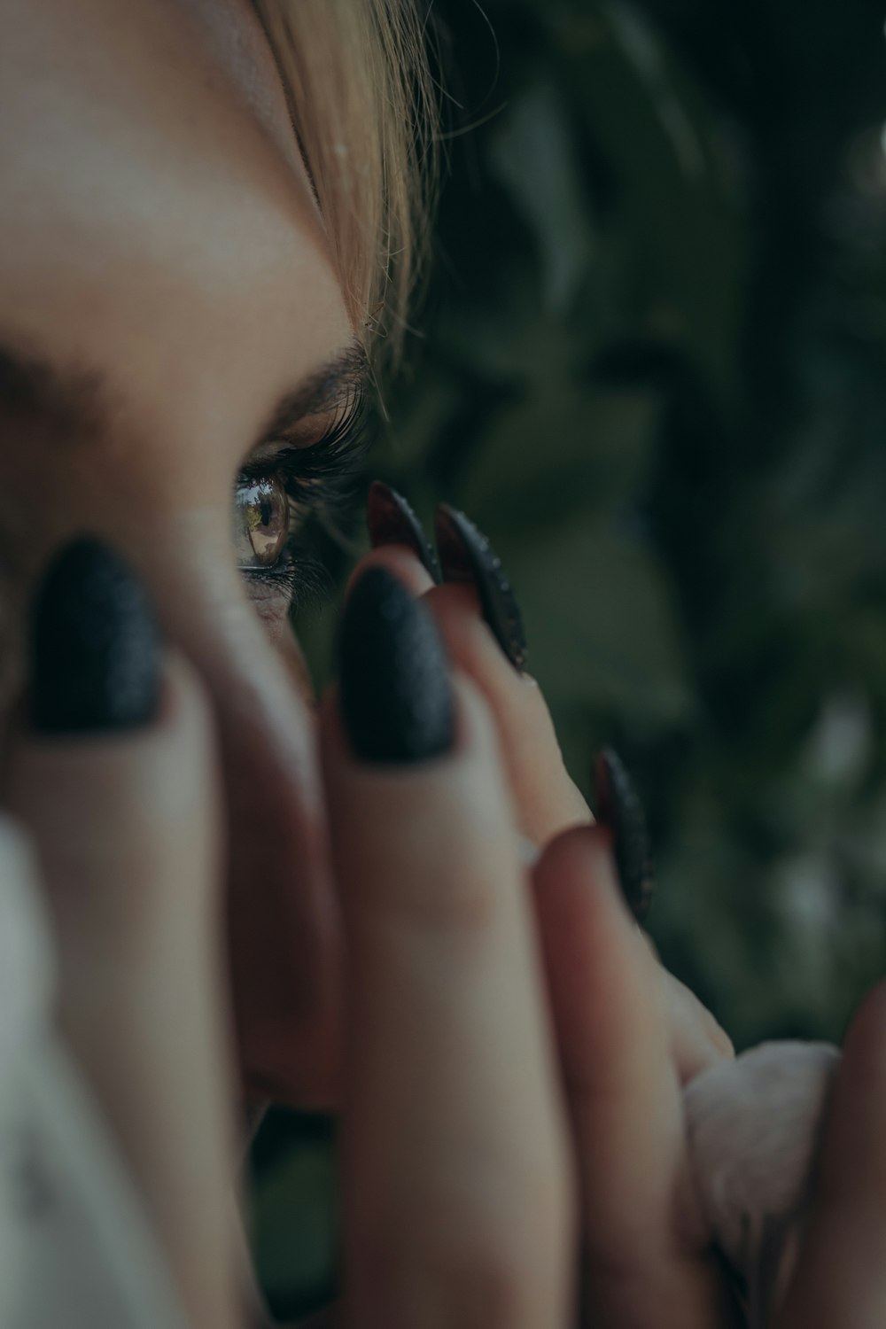 a woman holding her hand to her face