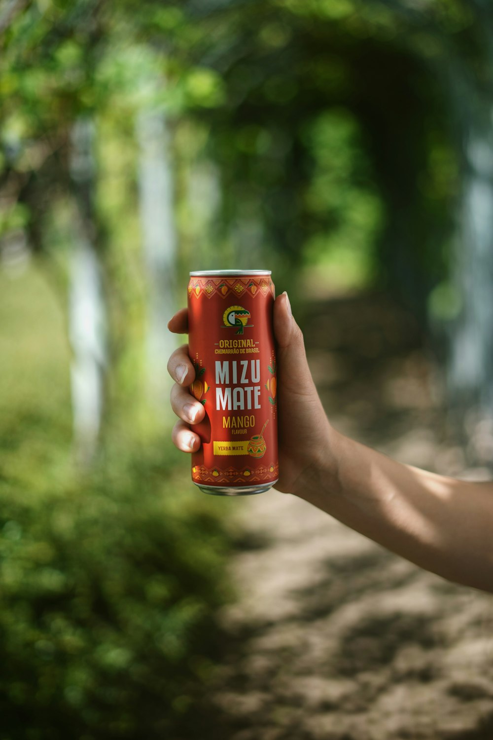 a hand holding a can of beer