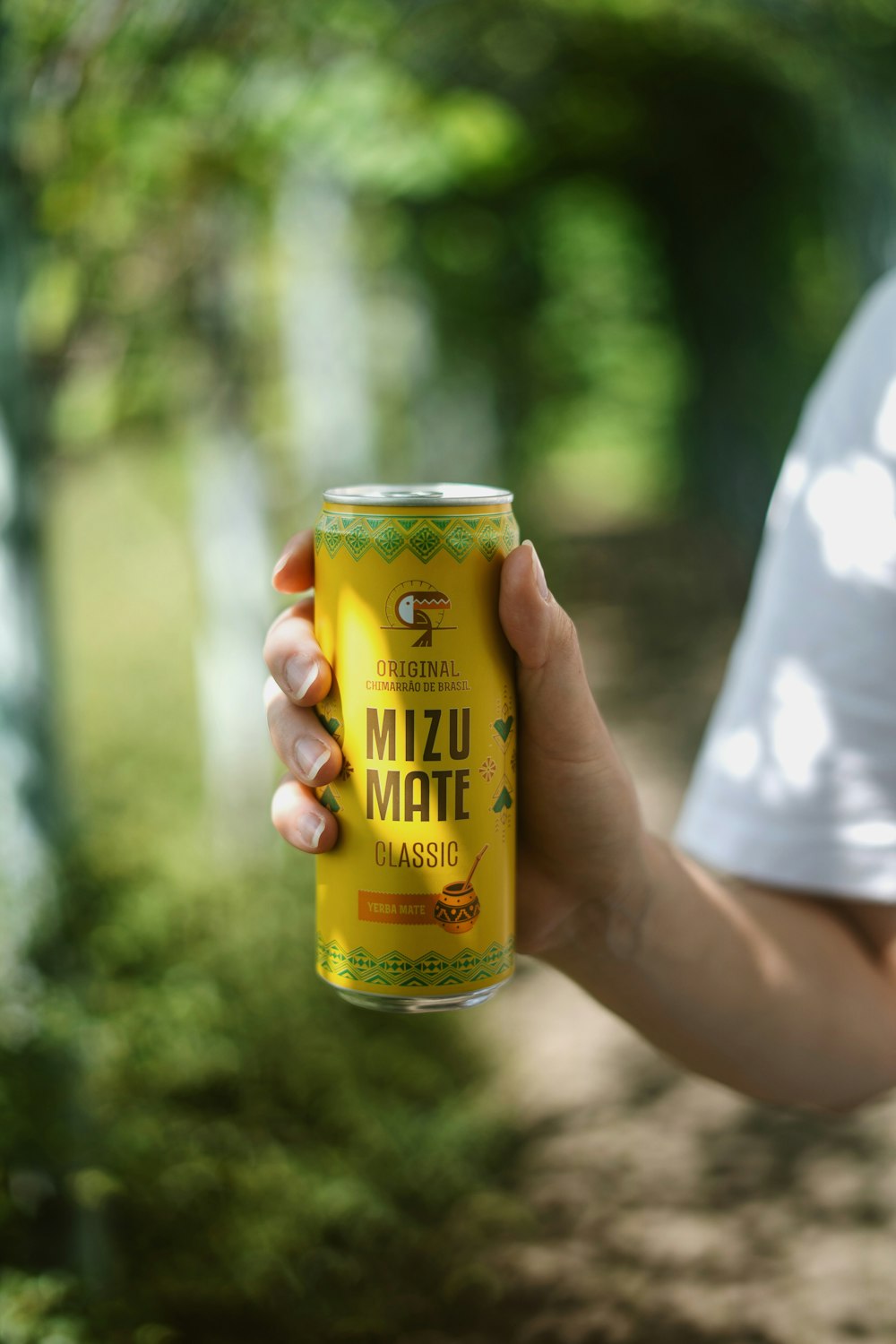 a hand holding a can of beer