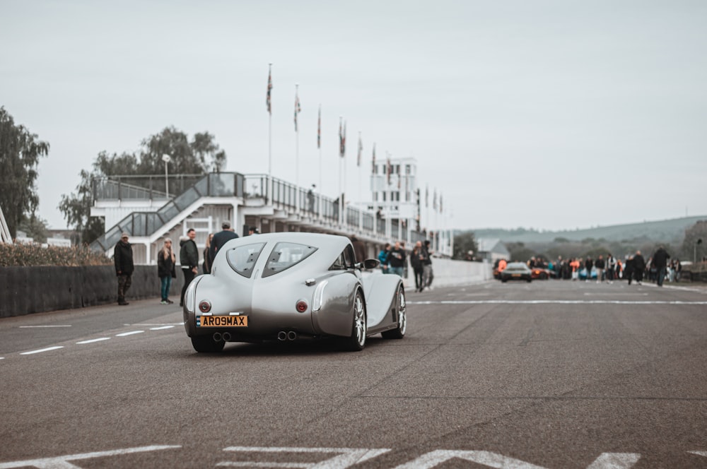 a car on a road with people around it