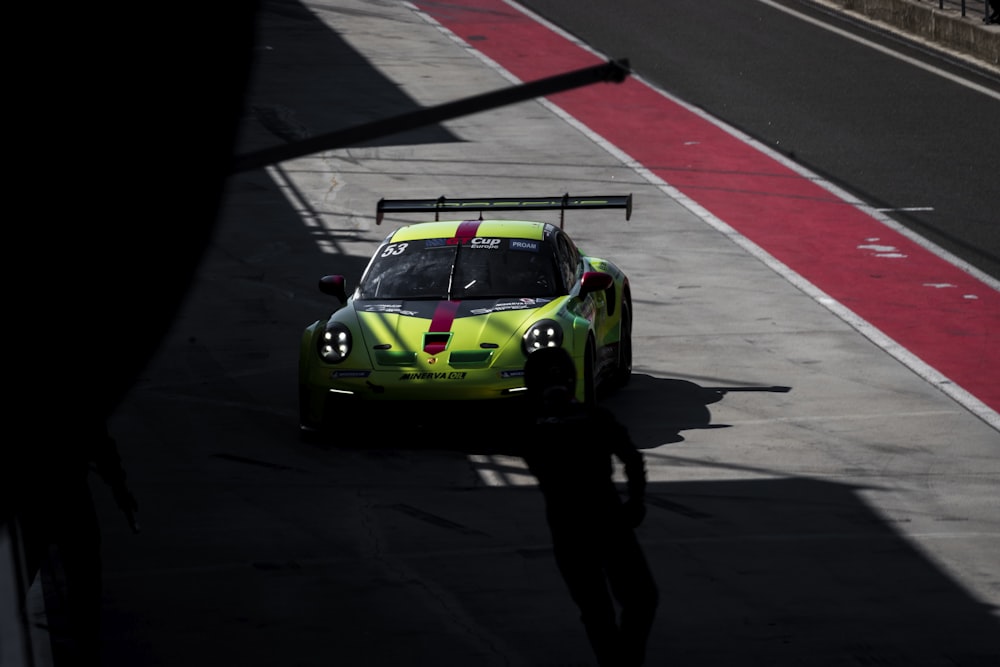 a person standing next to a race car on a track