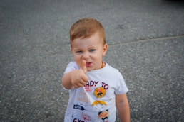 a baby with his finger in his mouth