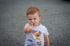 a baby with his finger in his mouth
