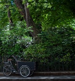 A compact cargo bike loaded with delivery boxes.