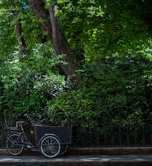 A compact cargo bike loaded with delivery boxes.