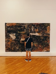 a person looking at a painting on a wall