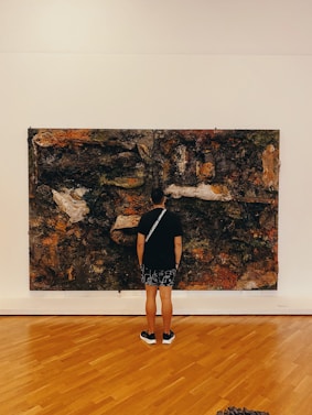 a person looking at a painting on a wall