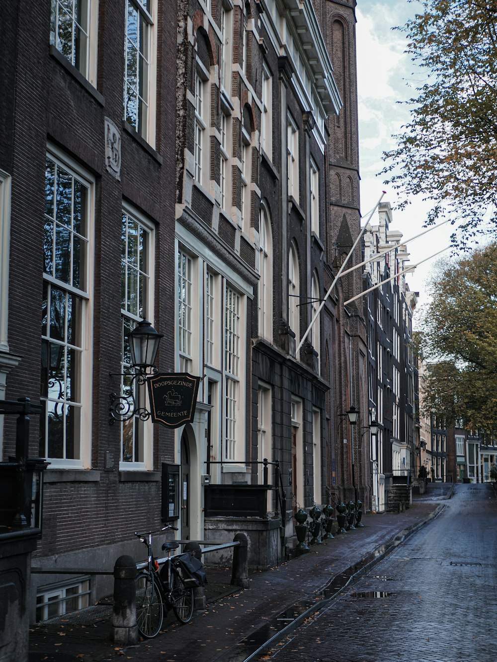a row of buildings with bicycles parked on the side
